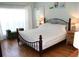 Main bedroom with king bed, hardwood floors, and soft natural light at 162 Gainesborough Dr, Dallas, GA 30157