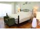 Spacious main bedroom with king-size bed and hardwood floors at 162 Gainesborough Dr, Dallas, GA 30157