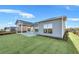 Newly sodded backyard with covered patio and privacy fence at 2798 Turnwater St, Hoschton, GA 30548