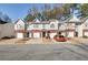 Front view of townhouses with attached garages and landscaping at 5321 Sherwin Dr, Norcross, GA 30093