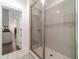 Modern basement bathroom with a large walk-in shower and gray tile at 5960 Overlook Club Cir, Suwanee, GA 30024