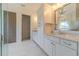 Elegant bathroom with double vanity, large mirror, and frameless shower at 5960 Overlook Club Cir, Suwanee, GA 30024