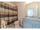 Bathroom with a shower/tub, granite countertop, and blue cabinets at 5960 Overlook Club Cir, Suwanee, GA 30024