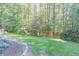 Spacious backyard with lush lawn and wooded backdrop at 9970 Groomsbridge Rd, Johns Creek, GA 30022