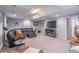 Spacious finished basement with a leather sectional sofa at 9970 Groomsbridge Rd, Johns Creek, GA 30022