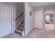 Basement stairs with carpet runner and neutral walls at 9970 Groomsbridge Rd, Johns Creek, GA 30022