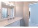 Modern bathroom with white vanity and quartz countertop at 9970 Groomsbridge Rd, Johns Creek, GA 30022