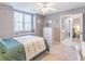 Spacious bedroom with green bedding and ensuite bathroom access at 9970 Groomsbridge Rd, Johns Creek, GA 30022