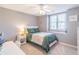 Well-lit bedroom with a green comforter and window seat at 9970 Groomsbridge Rd, Johns Creek, GA 30022