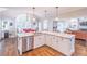 Island kitchen features granite countertops and hardwood floors at 9970 Groomsbridge Rd, Johns Creek, GA 30022