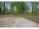 Large backyard with concrete patio and wooden fence at 1529 Bell Flower Ct, Stone Mountain, GA 30088