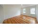 Well-lit bedroom with hardwood floors and two windows at 1529 Bell Flower Ct, Stone Mountain, GA 30088