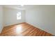 Simple bedroom with hardwood floors and a window at 1529 Bell Flower Ct, Stone Mountain, GA 30088