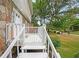 White wooden steps lead up to a deck overlooking a grassy yard at 1529 Bell Flower Ct, Stone Mountain, GA 30088