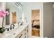 Double vanity bathroom with a view into the bedroom at 1963 Tripp Rd, Woodstock, GA 30188