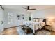 Bright bedroom with large windows, ceiling fan, and plush bedding at 1963 Tripp Rd, Woodstock, GA 30188