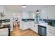 Updated kitchen with white cabinets, quartz countertops, and blue tile backsplash at 1963 Tripp Rd, Woodstock, GA 30188