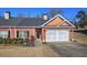 Brick home with attached garage and landscaping at 2500 Rosehill Cir, Lithia Springs, GA 30122