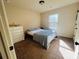 A cozy bedroom featuring neutral walls, plush carpet, and a comfortable bed with a patterned duvet at 3280 Hallmark Ln, Buford, GA 30519