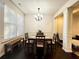 Bright dining room with hardwood floors, chandelier, and large window at 3280 Hallmark Ln, Buford, GA 30519