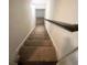 A carpeted staircase with a wooden handrail leading to the upper level of the home at 3280 Hallmark Ln, Buford, GA 30519