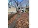 Side view of yellow house with a small yard and driveway at 1591 Woodland Se Ave, Atlanta, GA 30316