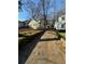 Yellow house on a tree-lined street with a shared driveway at 1591 Woodland Se Ave, Atlanta, GA 30316