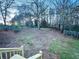 Large backyard with a wooden deck and a view of the treeline at 1626 Saddlecreek Rd, Auburn, GA 30011