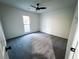 Spacious bedroom with grey carpet and a ceiling fan at 1626 Saddlecreek Rd, Auburn, GA 30011