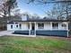 Newly renovated ranch home featuring a charming front porch and landscaped lawn at 1626 Saddlecreek Rd, Auburn, GA 30011