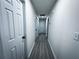 Long hallway with light grey flooring and white doors at 1626 Saddlecreek Rd, Auburn, GA 30011