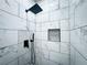 Modern shower with black fixtures and marble-look tile at 1626 Saddlecreek Rd, Auburn, GA 30011