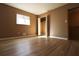 Bright bedroom featuring wood-look floors and an open closet at 2400 Reynolds Rd Sw, Atlanta, GA 30331