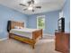 Bedroom with wood bed frame and ceiling fan, carpeted floor at 8926 East Carroll Rd, Winston, GA 30187