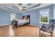 Main bedroom with hardwood floors, featuring a king-size bed and sitting area at 8926 East Carroll Rd, Winston, GA 30187