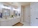 Double vanity bathroom with two sinks, mirrors, and a large linen closet at 1506 Lavista Proper Cir, Decatur, GA 30033