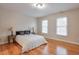 Bedroom with hardwood floors, two windows, and a comfortable bed at 1506 Lavista Proper Cir, Decatur, GA 30033