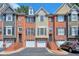 Three-story townhouses with attached garages and brick facade at 1506 Lavista Proper Cir, Decatur, GA 30033