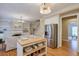 Open kitchen with white cabinets, island, and stainless steel appliances at 1506 Lavista Proper Cir, Decatur, GA 30033