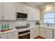 Kitchen with white cabinets, stainless steel appliances and hardwood floors at 1506 Lavista Proper Cir, Decatur, GA 30033