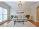 Living room with hardwood floors, sofa, and large windows at 1506 Lavista Proper Cir, Decatur, GA 30033
