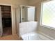 Bathroom with shower, tub, and closet at 1140 Sycamore Creek Trl, Sugar Hill, GA 30518