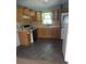 Efficient kitchen, with wood cabinets and vinyl flooring at 1551 Ferno Nw Dr, Atlanta, GA 30318