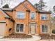 Brick two-story house with a two-car garage and landscaping at 1710 Aurelia Dr, Cumming, GA 30041