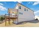 View of back exterior of the house featuring a covered deck, and walkout basement at 2131 Landsburg Way, Lawrenceville, GA 30043