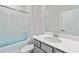 Bright bathroom featuring a shower-tub combo, toilet, and a neutral vanity at 2131 Landsburg Way, Lawrenceville, GA 30043