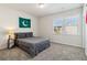 This bedroom features a window that allows natural light, carpeted floor, and a comfortable-looking bed at 2131 Landsburg Way, Lawrenceville, GA 30043