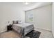 Cozy bedroom with neutral colors, carpeted floor, and a comfortable-looking bed at 2131 Landsburg Way, Lawrenceville, GA 30043