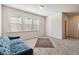 Bonus room with a blue couch and area rug at 2131 Landsburg Way, Lawrenceville, GA 30043