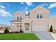 Charming two-story home with brick and siding, a well-manicured lawn, and an attached two-car garage at 2131 Landsburg Way, Lawrenceville, GA 30043